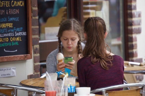 Girl with ice crem and mobile phone