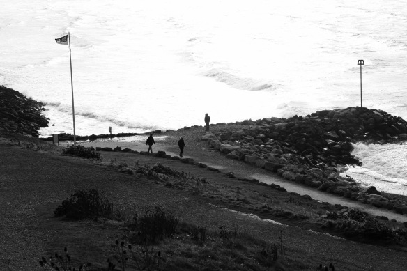 Walkers in silhouette, shore