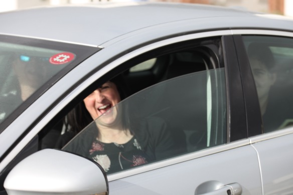 Woman in car laughing