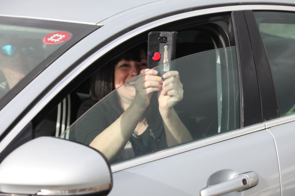 Woman in car photographing