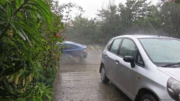Rain thrown up by blue car