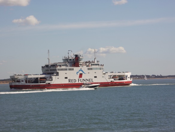 Speedboat passing Red Funnel ferryboat