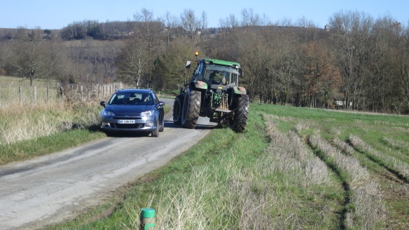 Tractor and car negotiating passage