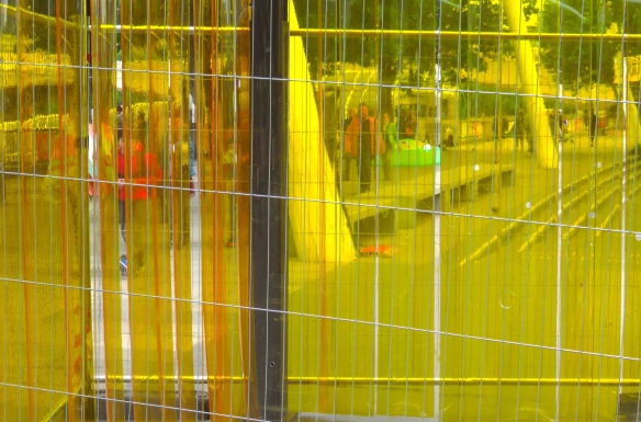 Yellow barriers and passers-by