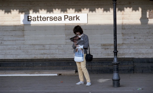 Young woman reading on platform 1984