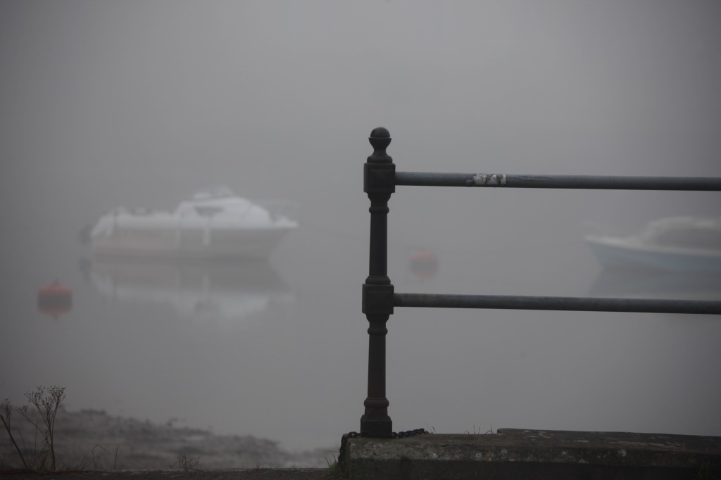 Railing and boats in fog