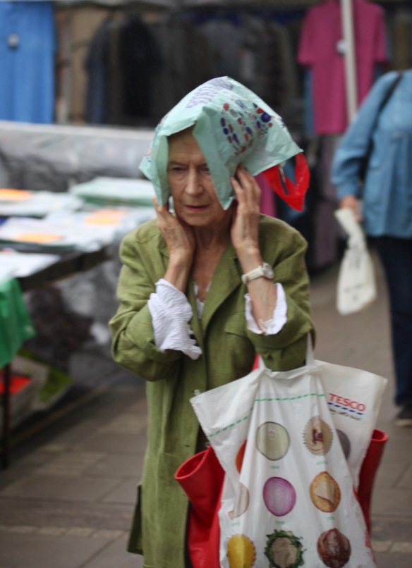 Woman keeping rain off with plastic bag